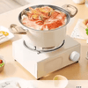 Compact Outdoor Gas Camping Stove cooking seafood in a pot on a portable white burner.