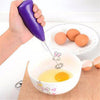 Coffee Milk Whisk Cappuccino Frother in use, frothing eggs in a bowl with a purple handheld electric whisk.