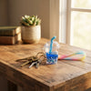 Floating Liquid Bubble Tea Cup Keychain on a wooden table with keys and a plant.