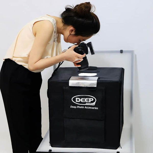 User capturing product photos with 40x40cm LED Deep Professional Photography Studio Light Box Set.