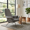 Zen Lounge Chair in a bright living space, featuring a sleek design and cozy ambiance with a table and plants.