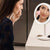 Woman applying makeup in front of the Beauty Breeze Mirror with adjustable LED lighting.