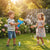 Children playing with the Handheld Bubble Blaster Set, creating bubbles in a sunny garden.