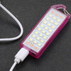 Mini Portable LED Keychain Flashlight in pink color with USB charging cable.