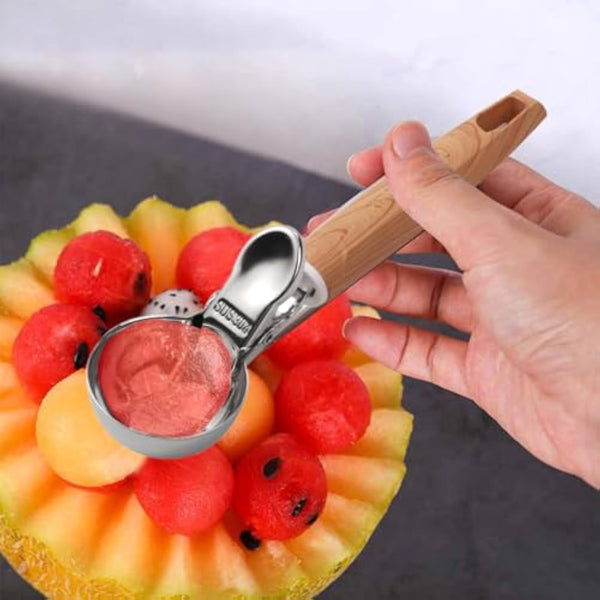 Stainless Steel Fruit & Dessert Scoop in use, scooping perfect balls of fruit from a melon bowl.