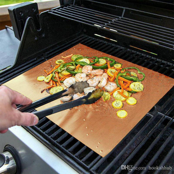 BBQ Grill Mat being used on a grill with assorted vegetables and shrimp for outdoor cooking.