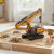 Alloy Crawler Crane Construction Toy displayed on a sand base with construction materials and signs.
