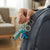 3D Cartoon Dinosaur Keychain attached to a backpack, featuring a playful dinosaur design.