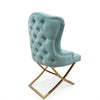 Cassander Dining Chair in blue velvet with a tufted back and gold metal base