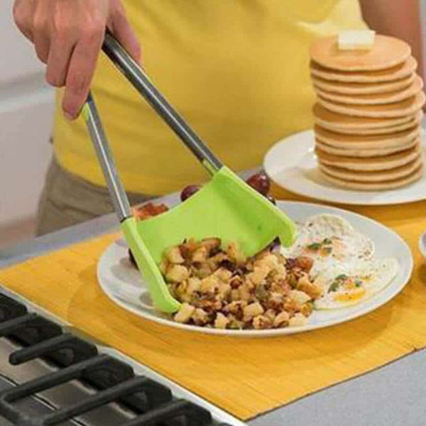 2 in 1 Clever Tongs in use, flipping and serving food from a plate in a kitchen setting.