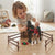 Child playing with Farm Horse & Rider Play Set, interacting with horse and rider figures in a farm-themed setting.