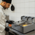 Chef using the 6.0L Stainless Steel Double Electric Deep Fryer to prepare crispy fries.