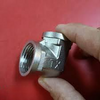 304 Stainless Steel 90 Degree Elbow Pipe Fitting held in hand, showcasing its threaded design for pipe connections.
