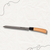 Serrated Bread Knife with Wood-Style Handle on a textured background.
