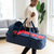 Woman carrying a Kid Baby Travel Bassinet Cribs Cot Bed in a stylish carrying bag for convenient travel.