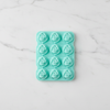 Flower-Shaped Silicone Ice Cube Tray displaying 12 flower-shaped ice molds on a marble surface.