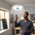 LED Chandelier with Solar Panel 400W in a workshop, man controlling it with a remote.