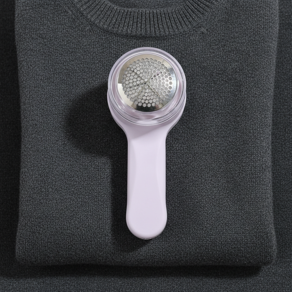 Rechargeable Lint Shaver & Fabric Defuzzer on a gray sweater, designed for effective lint removal.