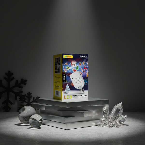 LED Christmas Projector Light box on display with festive imagery and decorations in a dark setting.