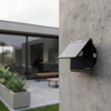 Solar Wall Light unit with integrated solar panel mounted on a concrete wall, providing outdoor lighting.