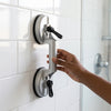 Suction Cup Lifter being used to lift tile safely, featuring secure grips on smooth surface.