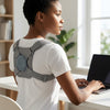 User wearing a Spine Posture Corrector and Back Support while sitting at a desk, promoting better posture.