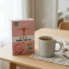 Womb Care Herbal Tea - Women’s Wellness & Herbal Infusion package next to a steaming cup of tea on a wooden table.