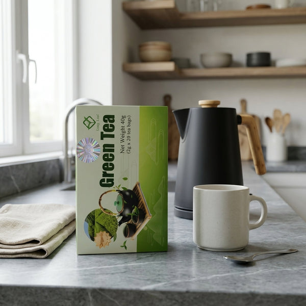 Pure Antioxidant Green Tea packaging on a kitchen counter with a kettle and mug, showcasing a healthy beverage choice.