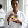 Eczema And Psoriasis Soap held by a woman in a white robe, showcasing its soothing benefits for irritated skin.