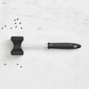 Meat hammer kitchen tenderiser tool with ergonomic handle on a marble countertop.