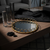 American Round Loop Mirror Tray in Gold - Medium displayed on a wooden table with decorative elements.