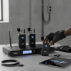 Andowl Qmic78 Set Wireless Microphone with wireless transmitters and receiver on a sleek table.