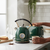 1.7L Stainless Steel Cordless Electric Kettle with Keep Warm brewing tea with steam and toast in a cozy kitchen.