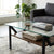 Modern Adjustable 1-Tier or 2-Tier Glass and Wood Coffee Table in a chic living room setting with a cozy aesthetic.