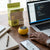 M3 Macaron Mini Wireless Speaker on a desk next to a laptop and phone, showcasing its portable design.