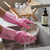 Heat Resistant Silicone Scrubber Magic Gloves in action, washing a bowl at the sink with running water.