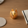 Gold Leaf Tealight Candle Holder illuminating a table, adding elegance and a cozy atmosphere.