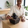 Indoor Tabletop Water Fountain Decor with stones, providing a calming experience in a workspace.