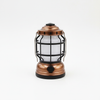 Rechargeable Waterproof Camping Lantern with a copper finish and protective grid for outdoor use.