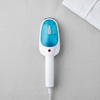 Travel Portable Iron Steamer on a light fabric background next to a white shirt for wrinkle-free clothing.
