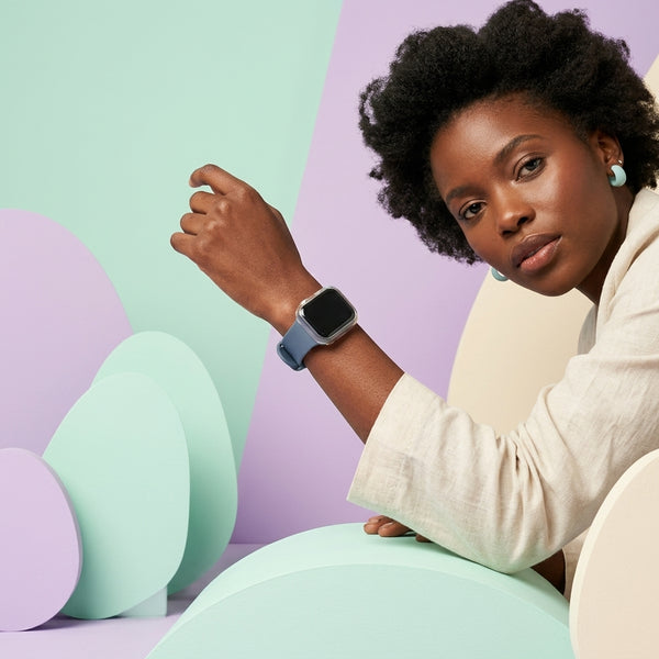 Rugged Silicone Sport Band for Apple Watch Ultra displayed on a model's wrist with colorful geometric background.
