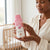 A parent holding Vitamin E Enriched Baby Body Cream in a cozy nursery setting.