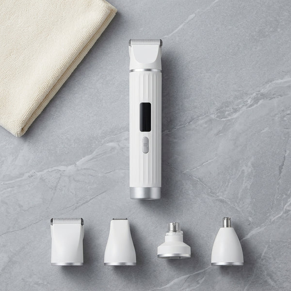 USB Rechargeable Professional Pet Grooming Trimmer with multiple attachments and a towel on a gray surface.