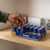 Person picking D Cell Batteries 24 Pack from a shelf, showcasing reliable power for everyday devices.