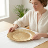 Woman setting a 13-Inch Eco-Friendly Wedding Charger Plate on a table, enhancing elegant dining presentation.