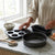3 Piece Non Stick Bakeware Set displayed on a kitchen countertop, showcasing a muffin pan, loaf pan, and round cake pan.