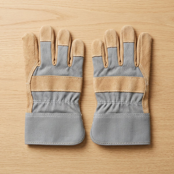 Heat Resistant Anti-Chemical Leather Working Gloves displayed on a wooden surface, showcasing their durable design.