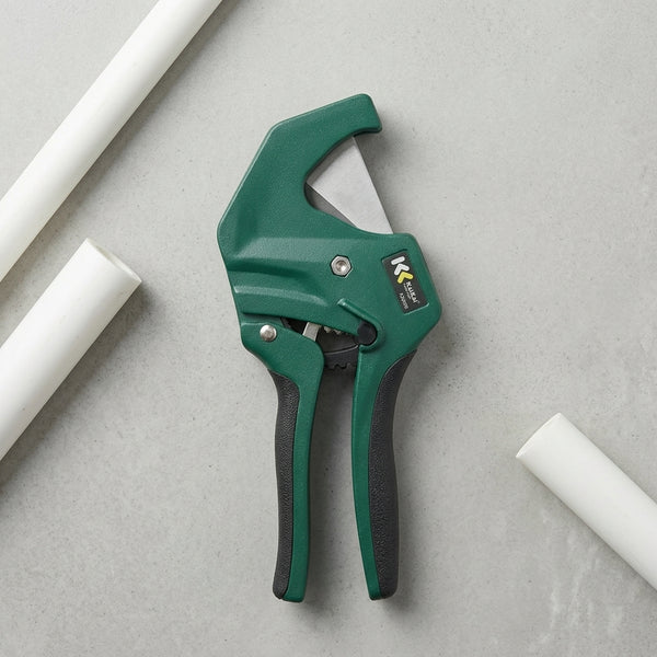 42mm PVC Pipe Cutter Tool on a gray surface with white PVC pipes, designed for clean and precise cuts.
