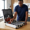 Man using the Hand Tool Combination Set from an open toolkit, showcasing various hand tools and a portable case.