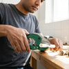 Person using a 42mm PVC Pipe Cutter Tool on white piping during plumbing work.